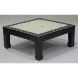 A Chinese ebonized elm coffee table, the top inset with a thick granite panel, raised on block legs,