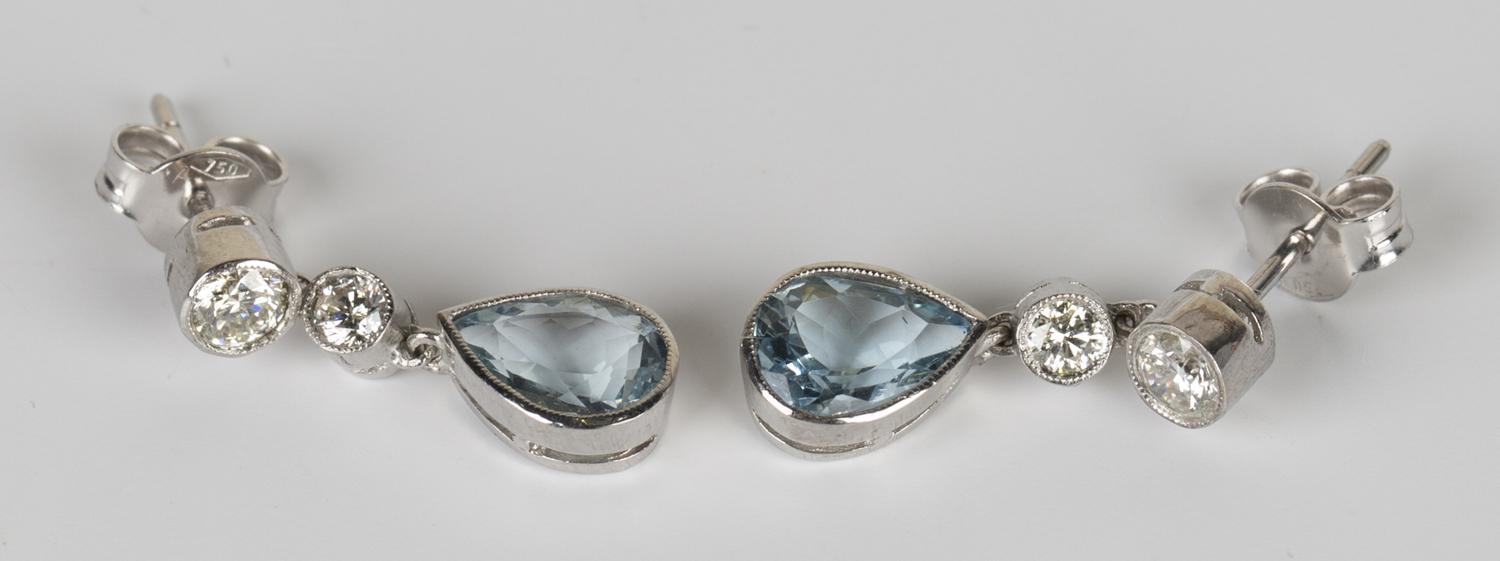 A pair of white gold, aquamarine and diamond pendant earrings, each collet set with a pear shaped