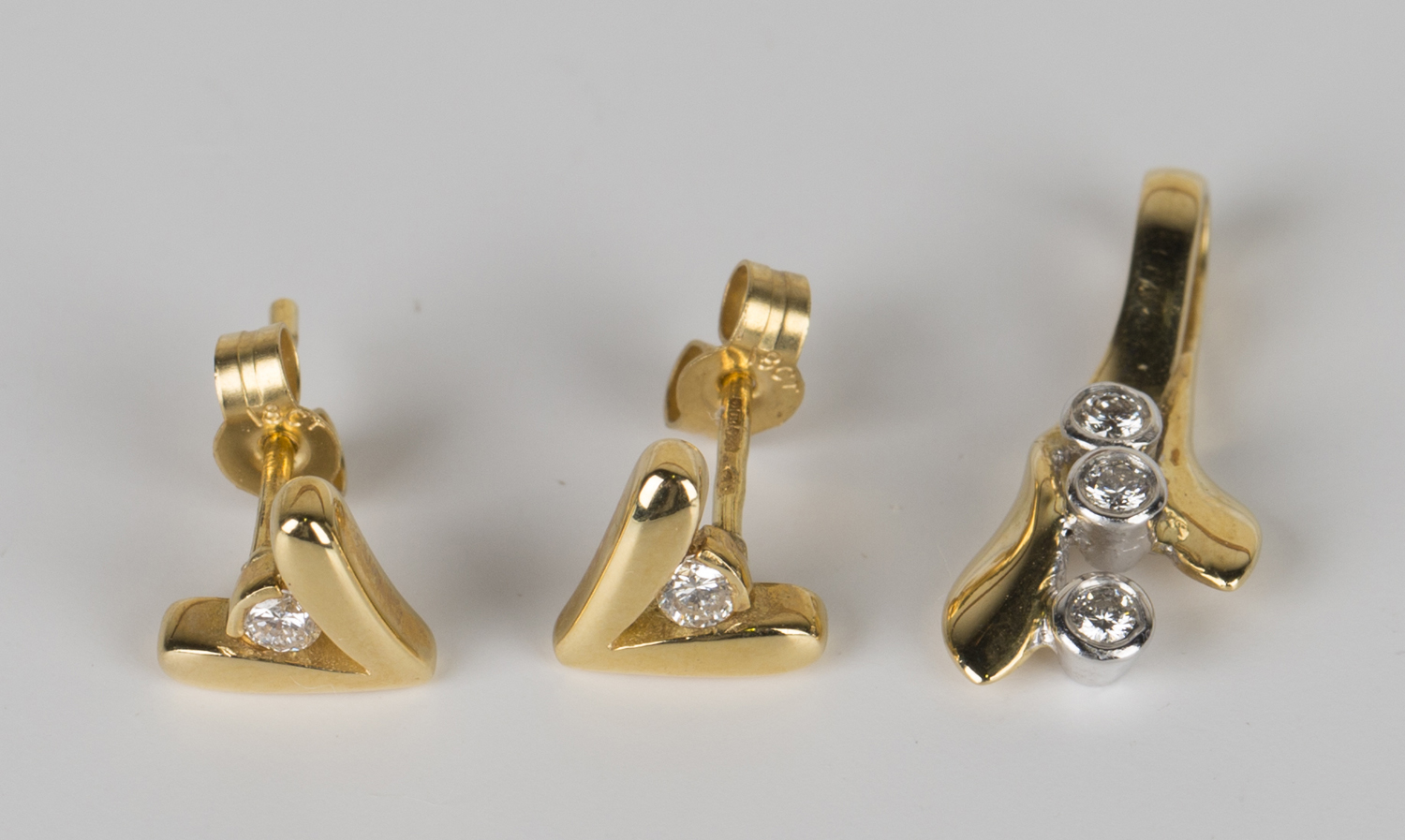 A pair of 18ct gold and diamond earrings, each in a 'V' shaped design centred by a circular cut