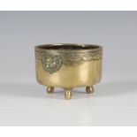 A Chinese polished bronze censer, mark of Xuande but Qing dynasty, of cylindrical form with reeded