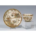 A Japanese Satsuma earthenware cabinet cup and saucer by Kaizan, Meiji period, the cup exterior