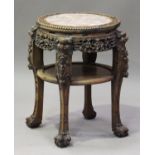 A Chinese hardwood jardinière stand, late 19th century, the circular top inset with a rouge marble