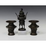 A pair of Japanese brown patinated bronze vases, Meiji period, each baluster body cast in relief