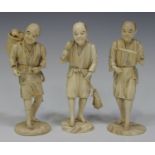 A group of three Japanese carved sectional ivory okimono figures of male workers, Meiji period, each