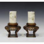 A pair of Japanese ivory tusk vases and wood stands, Meiji period, each tusk section incised and