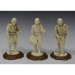 A group of three Japanese carved ivory okimono figures of a fisherman and two farmers, Meiji period,