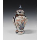 A Japanese Imari porcelain jar and domed cover, early 18th century, of baluster form, painted and