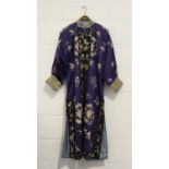 A Chinese purple silk embroidered robe, early 20th century, worked in coloured threads with bat