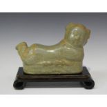 A Chinese Song style celadon glazed pottery pillow, modelled as a recumbent boy, length 22.5cm (