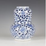 A Chinese blue and white porcelain vase, mark of Kangxi but late 19th century, of swollen gourd