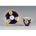 An unusual and rare Sèvres Republican bleu-nouveau-ground two-handled goblet and saucer, circa 1793,