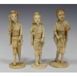 A group of three Japanese carved sectional ivory okimono figures of female workers, Meiji period,