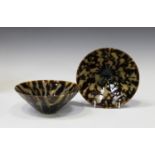 A near pair of Chinese Song style stoneware bowls, each of circular conical form, covered in a