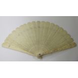 A Chinese Canton export ivory brisé fan, late 19th century, the pair of guards carved in relief with