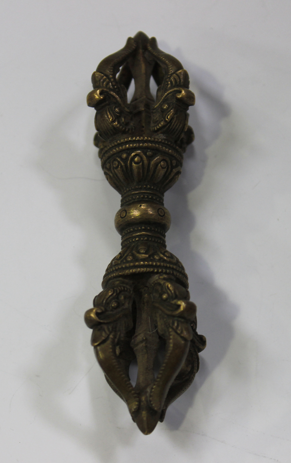 A Tibetan bronze vajra, probably late 19th/early 20th century, each end formed as a crown, centred - Image 2 of 2