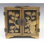 A Japanese lacquer kodansu, Meiji period, of rectangular form with copper handle, hinges and mounts,