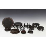A collection of twenty-two mostly Chinese circular wooden stands, late Qing dynasty and later, of