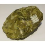 A Paleolithic yellow stone axe head, bearing F.S. Clark label and monogram, detailed 'Mill End',