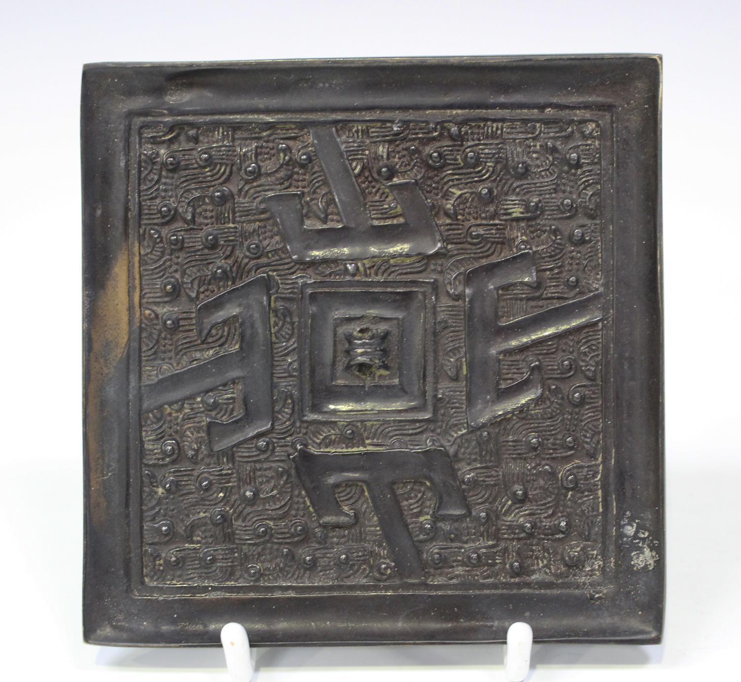 A Chinese archaic bronze square mirror, probably Warring States period (480-221 BC), one side cast