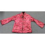 A Chinese pink silk embroidered short jacket, 20th century, decorated with birds, flowers and shou