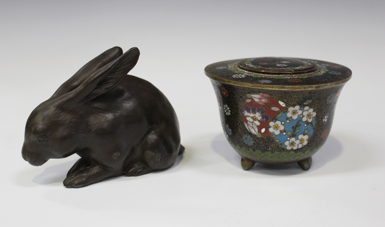 A Japanese brown patinated metal figure of a rabbit, early 20th century, stamped seal mark to