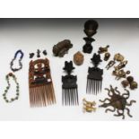 A group of African collectors' items, including a pair of carved wooden combs, another larger