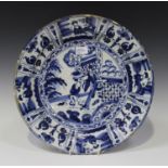 A Dutch Delft Kraak style blue and white charger dish, circa 1760, centrally painted with two