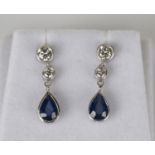 A pair of white gold, sapphire and diamond pendant earrings, each with a pear shaped sapphire and