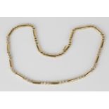 An 18ct gold and diamond necklace, designed as baton and circular shaped links, the front with
