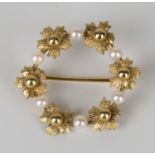 A 9ct gold and cultured pearl brooch, designed as a floral wreath, Birmingham 1978, width 2.9cm.
