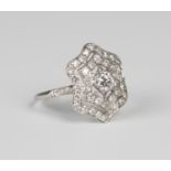 A white gold and diamond ring, collet set with the principal circular cut diamond within an openwork