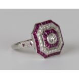 A platinum, diamond and ruby ring, collet set with the principal circular cut diamond in a cut