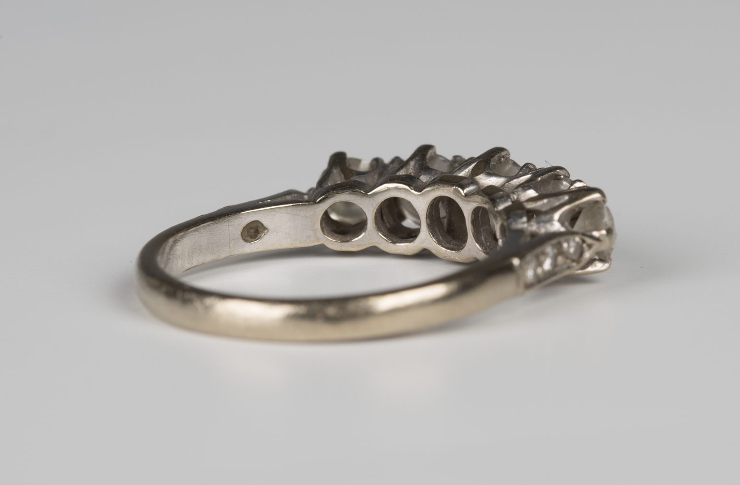 A white gold and diamond five stone ring, claw set with a row of circular cut diamonds graduating in - Image 2 of 2