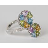 A white gold, vari-coloured topaz and diamond twin cluster ring, designed as two graduated