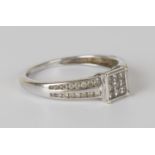 A 9ct white gold and diamond square cluster ring, mounted with nine princess cut diamonds between