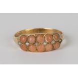 An 18ct gold, coral and seed pearl ring, mounted with two rows of corals and a row of seed pearls to
