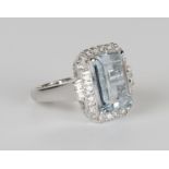 An 18ct white gold, aquamarine and diamond cluster ring, claw set with a rectangular cut