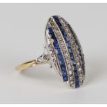 An 18ct gold, sapphire and diamond oval panel shaped ring, mounted with three rows of square cut