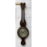 An early 19th century mahogany wheel barometer with alcohol thermometer and silvered dials,