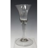 A plain stem wine glass, mid-18th century, the bell shaped bowl raised on a plain stem and folded