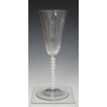 A single series opaque twist stem ale glass, mid-18th century, the rounded funnel bowl raised on a