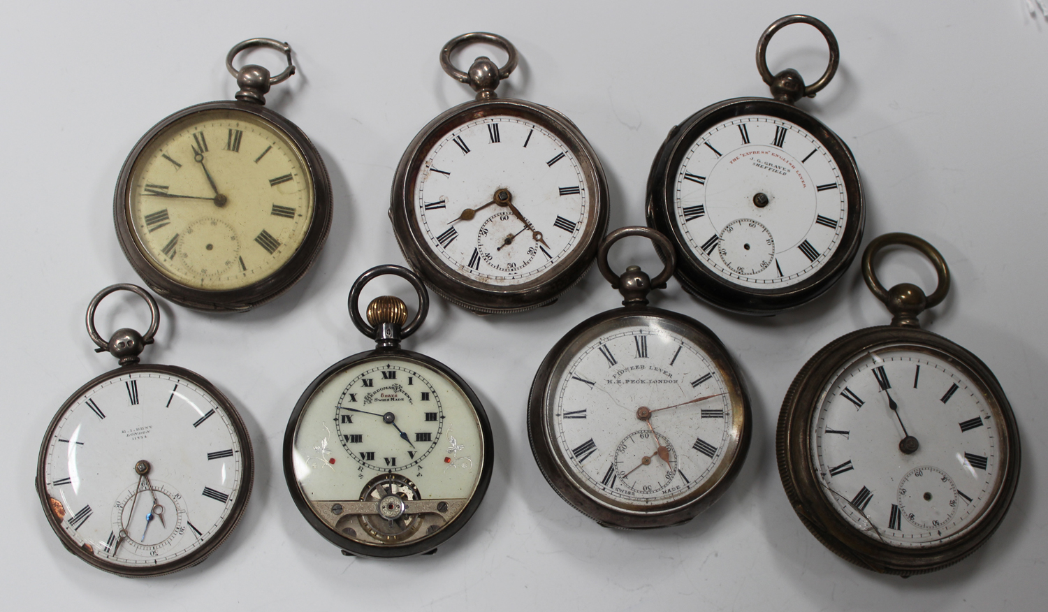 A silver cased keyless wind open-faced pocket watch with visible escapement, detailed 'Hebdomas