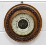 A late Victorian walnut cased circular wall barometer, the dial detailed 'J. Casartelli & Son...