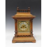 A late 19th century German walnut mantel clock with 14-day movement striking on a gong, the