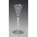 A double series opaque twist stem wine glass, mid-18th century, the flared trumpet bowl raised on