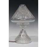 A Tudor cut glass table lamp, mid-20th century, the cone shaped shade supported on a waisted stem