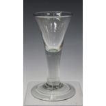 A tall firing glass, mid-18th century, the drawn trumpet bowl raised on a plain stem and folded