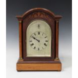 An early 20th century mahogany mantel clock with eight day movement striking and chiming on gongs,