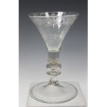 A Dutch engraved soda glass, early 18th century, the trumpet bowl engraved with a band of