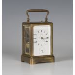 A late 19th century French brass cased carriage alarm clock with eight day movement repeating on a